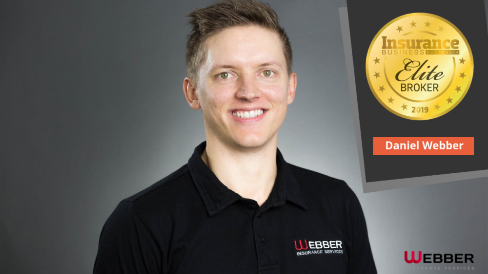 A man with short hair, wearing a black polo shirt with "WEBBER Insurance Services" embroidered on it, is smiling. Next to him is a gold badge stating "Daniel Webber Elite Broker 2019." The Webber logo is in the bottom right.