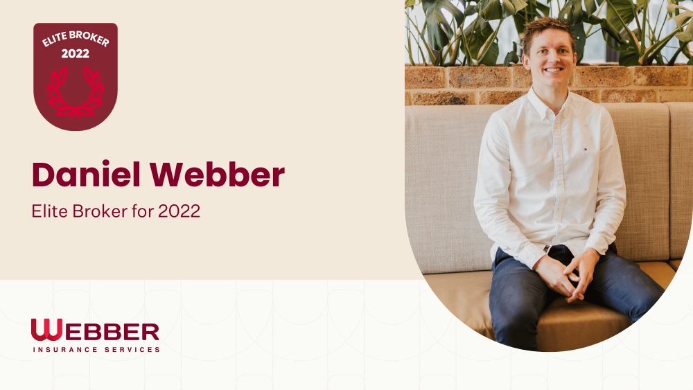 A man in a white shirt and dark pants is sitting on a beige couch, smiling. The text reads "Daniel Webber, Elite Broker for 2022" next to a badge that says "Daniel Webber Elite Broker 2022" above the logo "Webber Insurance Services." The background is beige with plants visible.