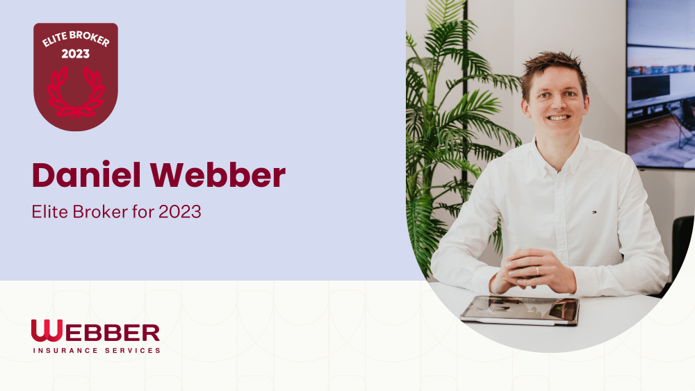 A man in a white shirt, identified as Daniel Webber, sits at a desk with a tablet. The text reads "Elite Broker 2023" and "Daniel Webber, Elite Broker for 2023" against a light blue background. The logo for Webber Insurance Services is prominently visible at the bottom.