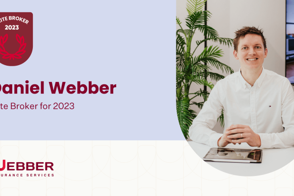 A man in a white shirt, identified as Daniel Webber, sits at a desk with a tablet. The text reads "Elite Broker 2023" and "Daniel Webber, Elite Broker for 2023" against a light blue background. The logo for Webber Insurance Services is prominently visible at the bottom.
