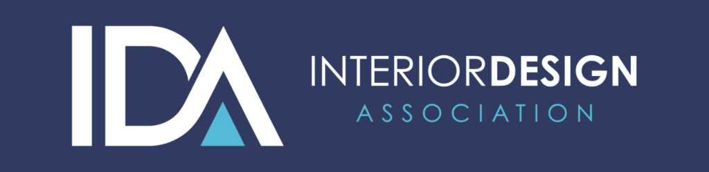 Logo for the Interior Design Association (IDA). The design features the acronym "IDA" in bold white letters on a dark blue background, with the "A" containing a light blue triangle. "INTERIOR DESIGN ASSOCIATION" is written in white and light blue text, symbolizing creativity and professionalism in interior design insurance.