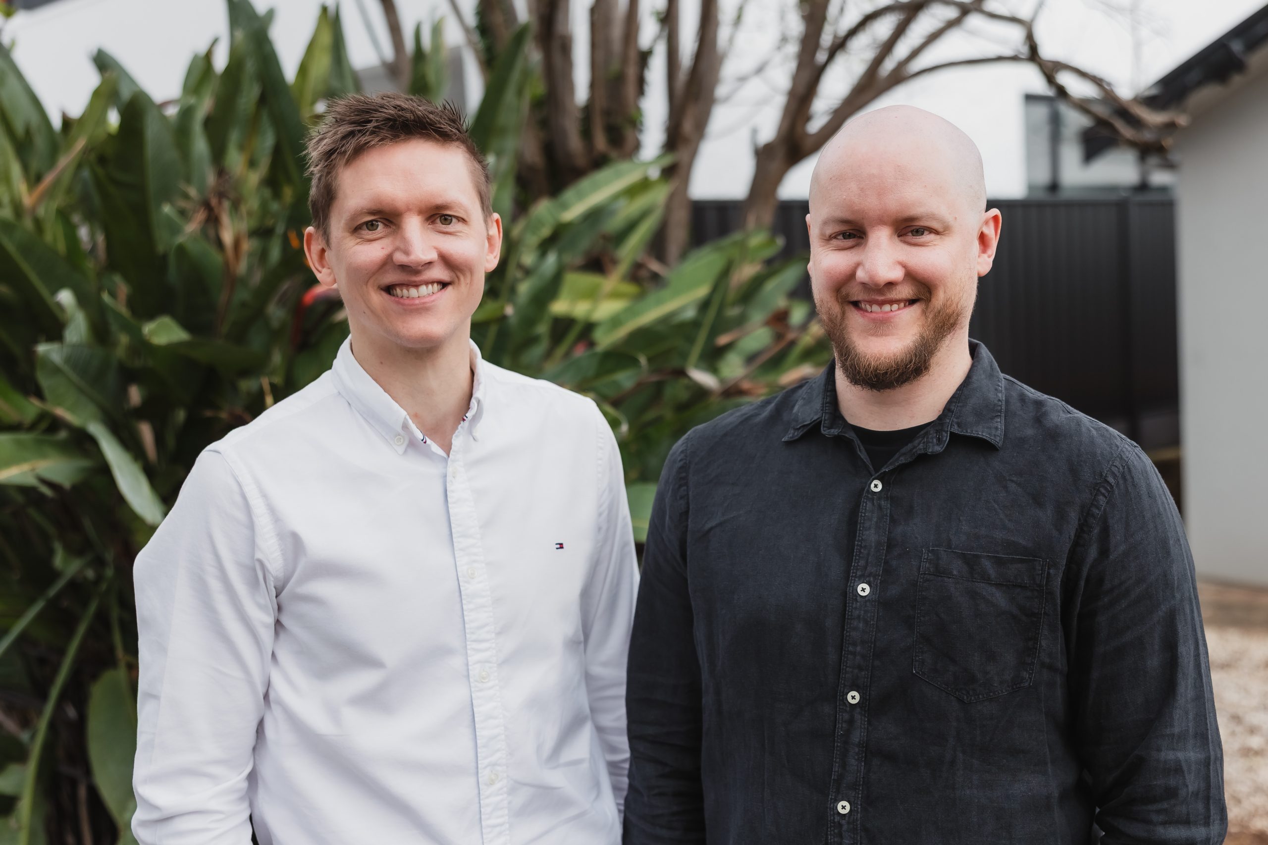 Two Webber Insurance brokers smiling outdoors